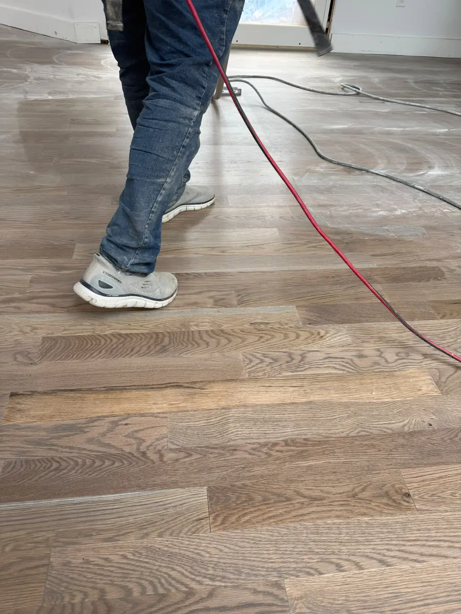 Buffing a plank floor before the finish