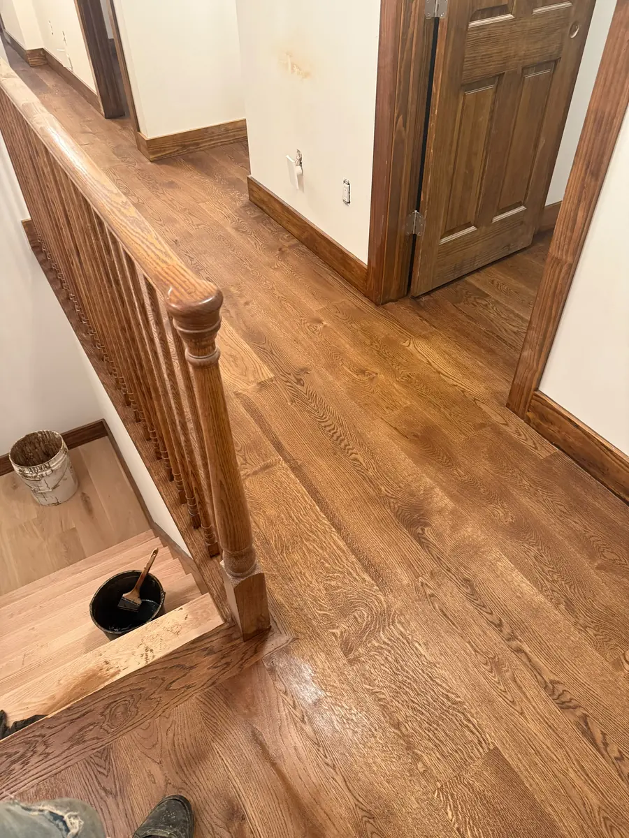 Hardwood stairs and railing being finished